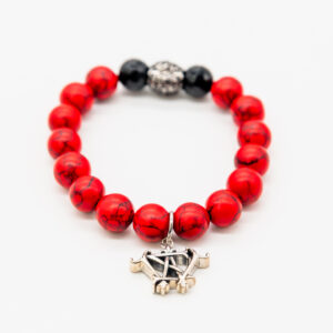 Red beaded bracelet with silver charm.