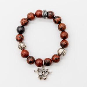 Red jasper beaded bracelet with silver charm.